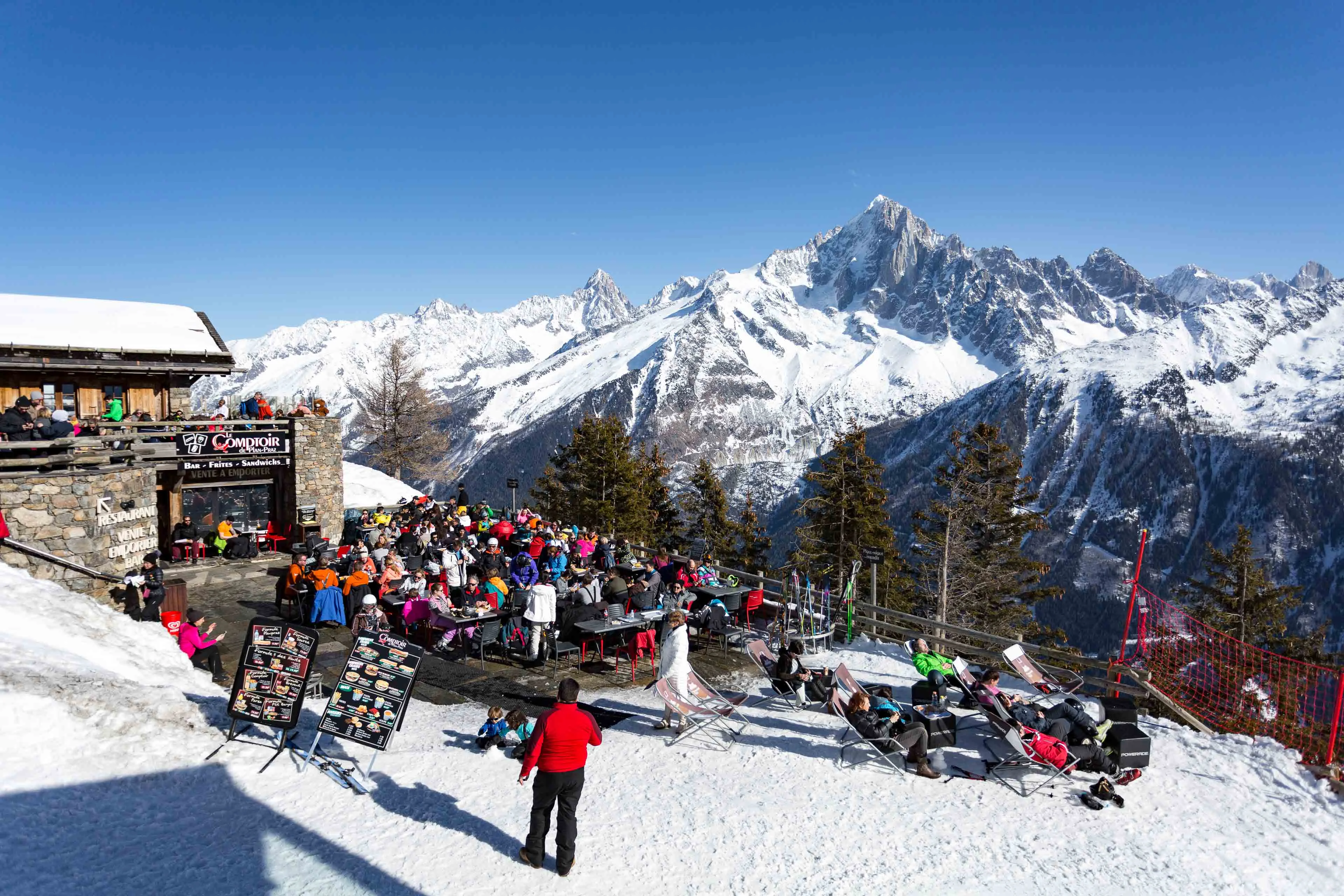 Terrasse animée du restaurant d'altitude de Plan Praz au-dessus de Chamonix, face à l'Aiguille Verte et aux Drus