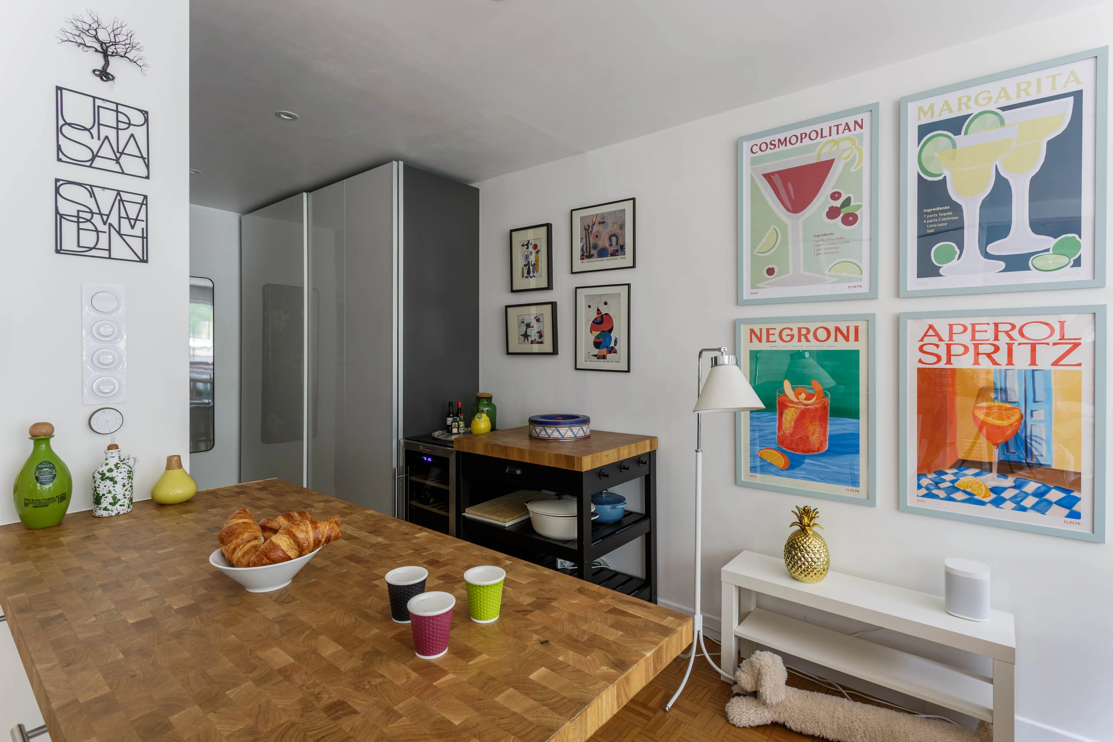 Kitchen worktop with croissants in a Chamonix apartment, with framed prints on the wall behind