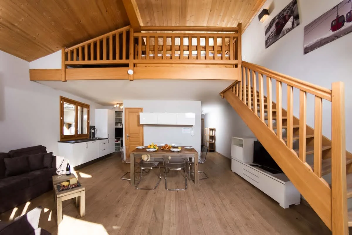 Staircase leading up to mezzanine area and additional bedroom