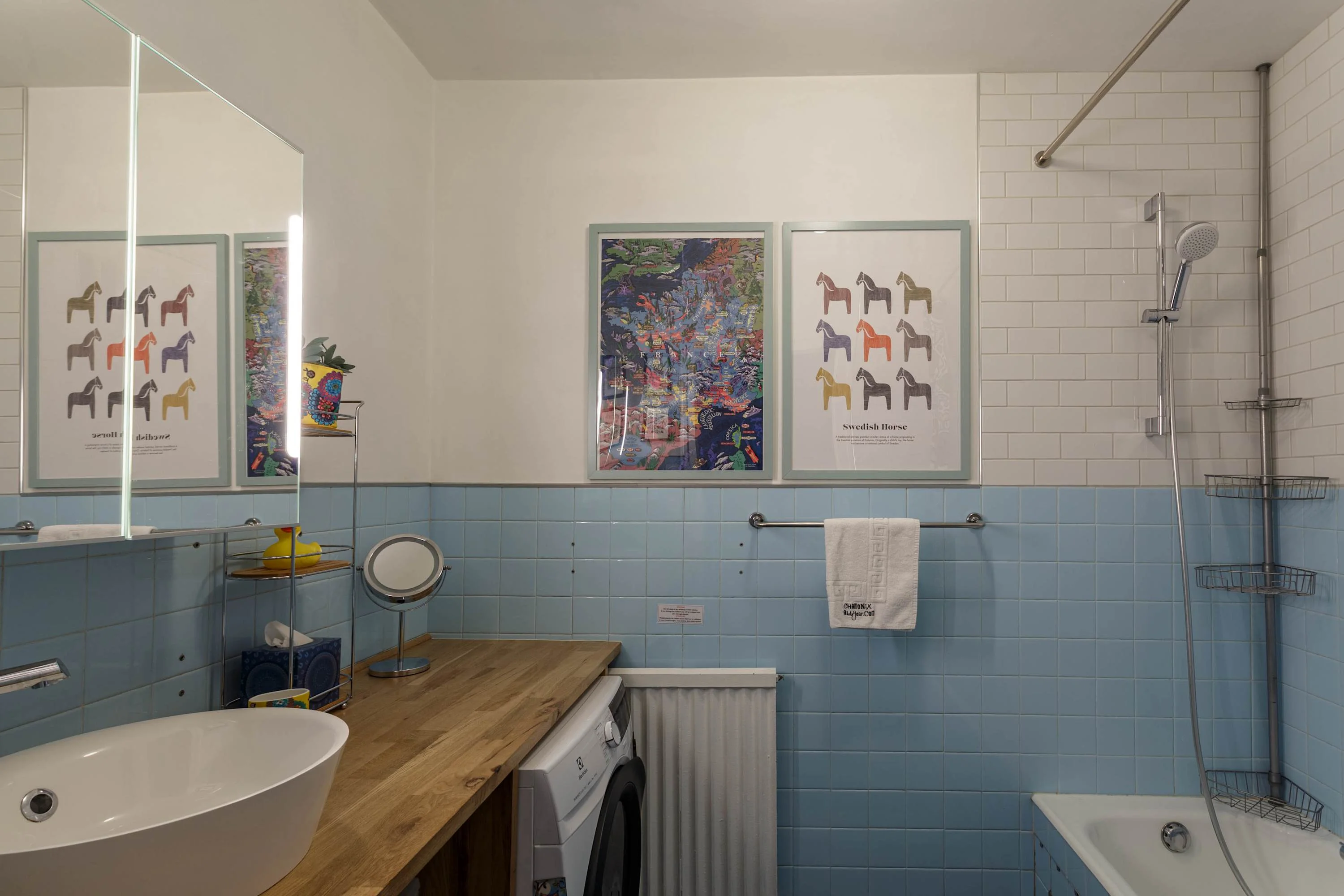 There is a bath with an overhead shower to enjoy