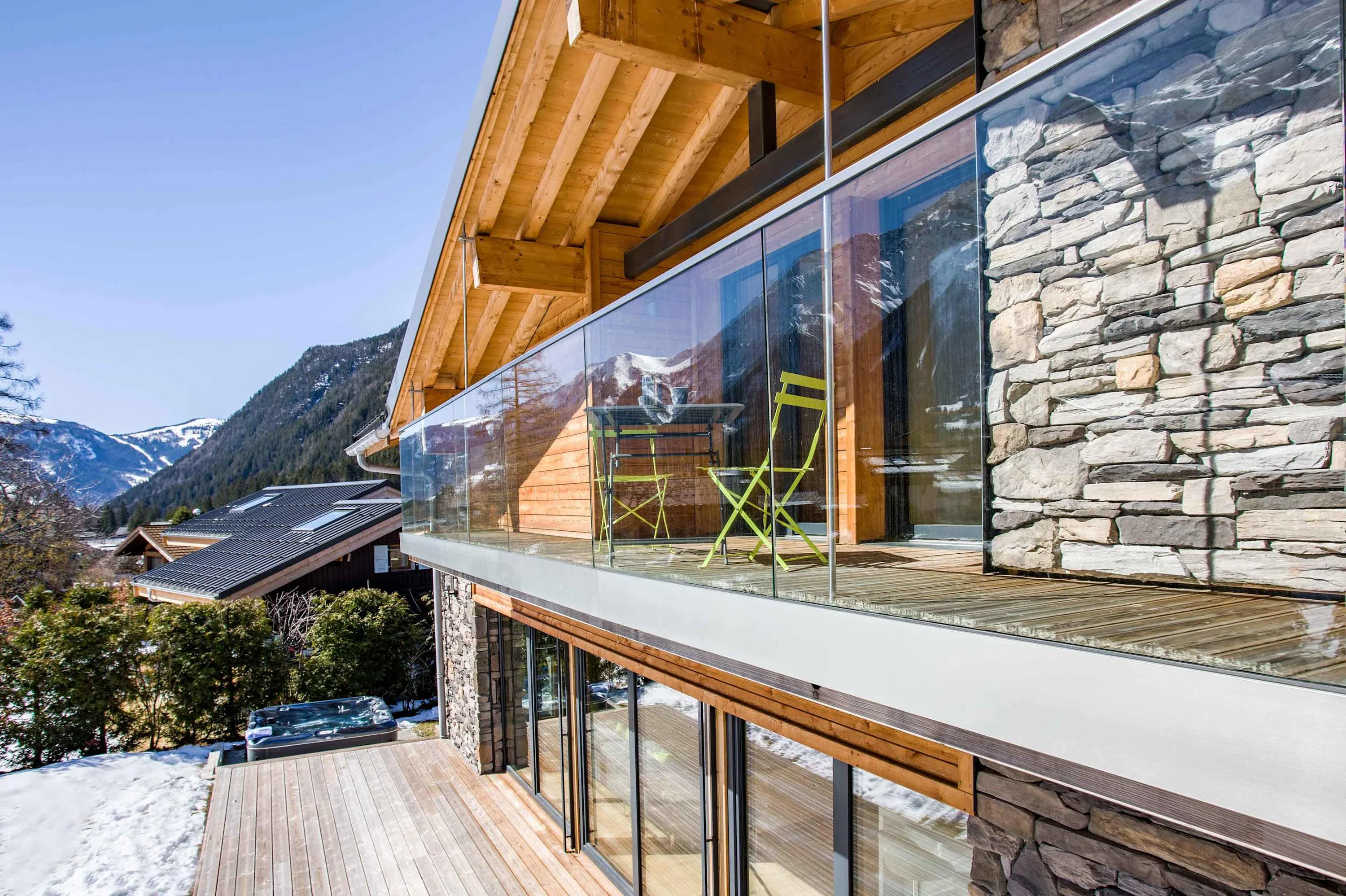 The mountains are reflected in the glass balcony