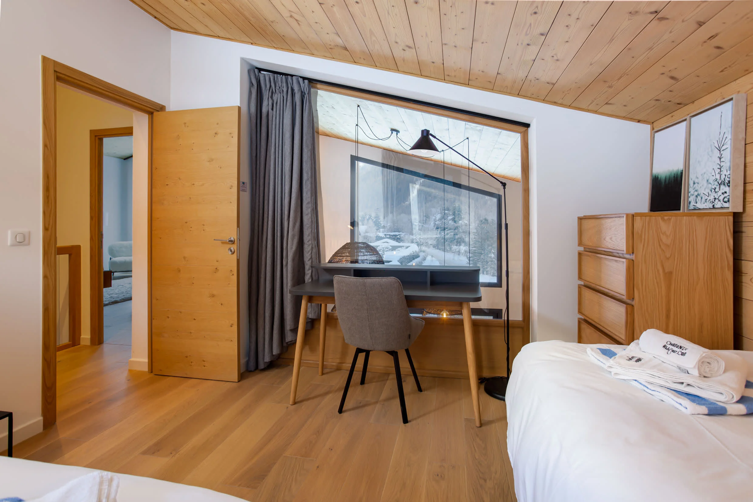 Upstairs twin bedroom with large window over looking living area