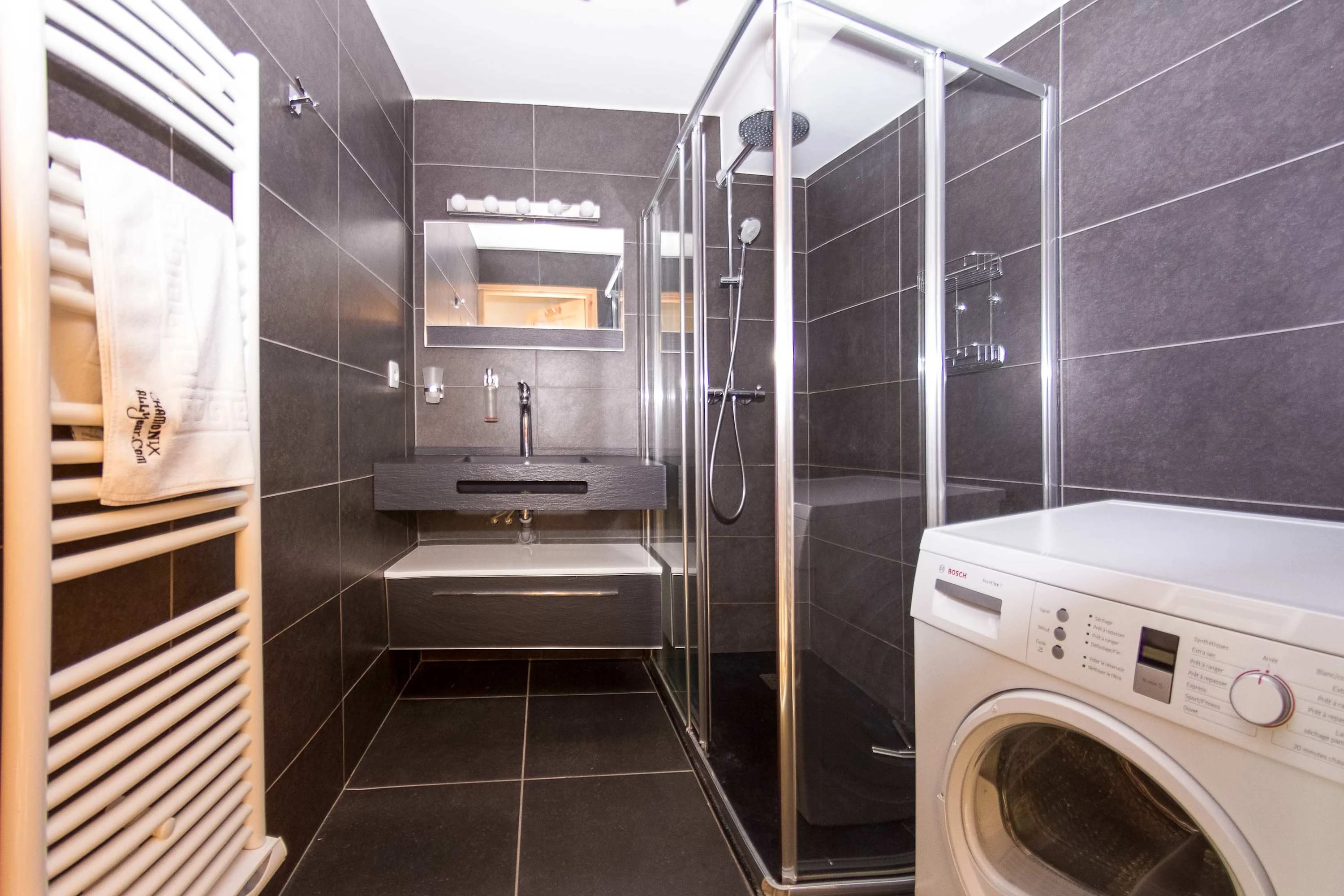 Main bathroom downstairs with shower and washing machine