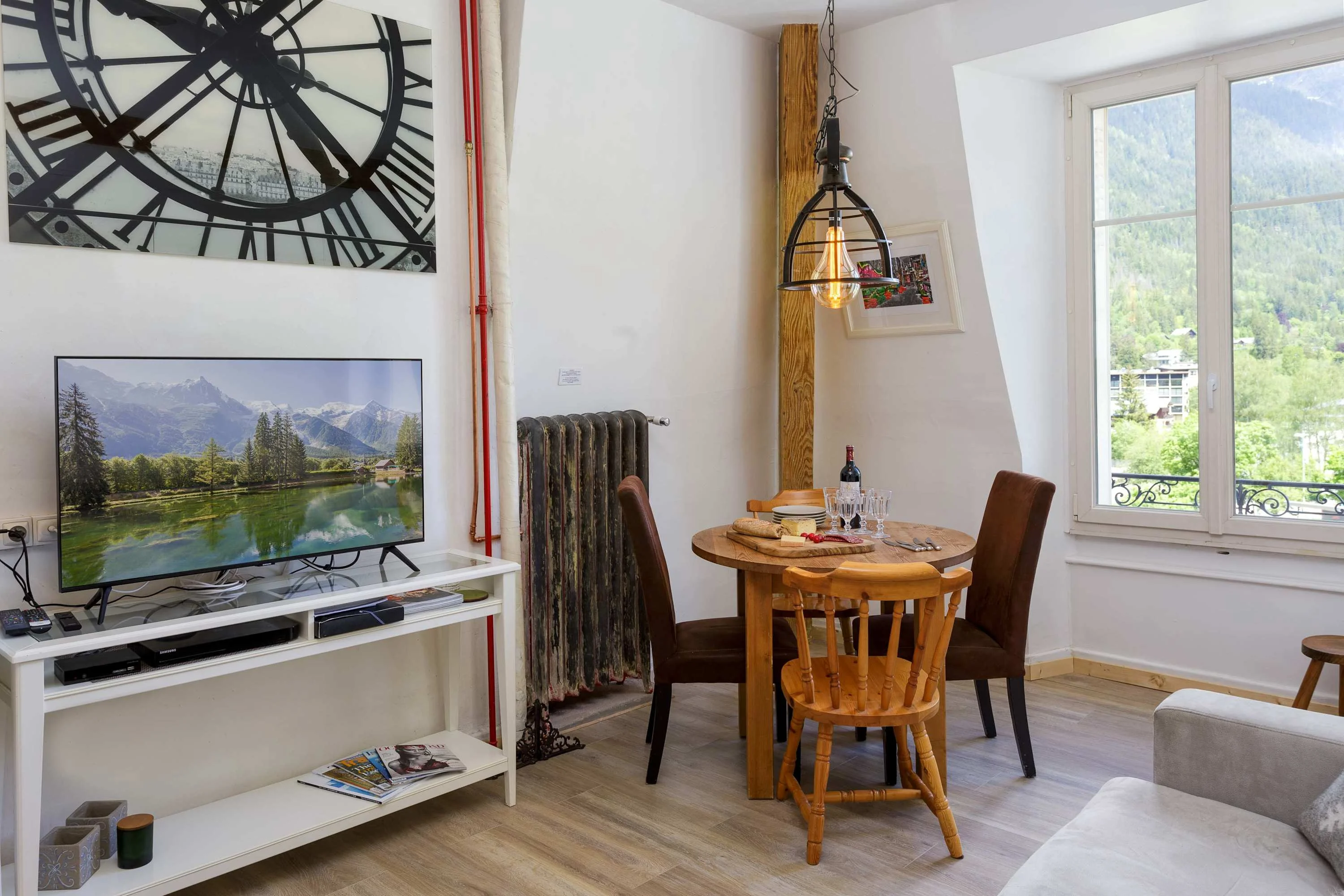 Open-plan lounge and dining area with large TV