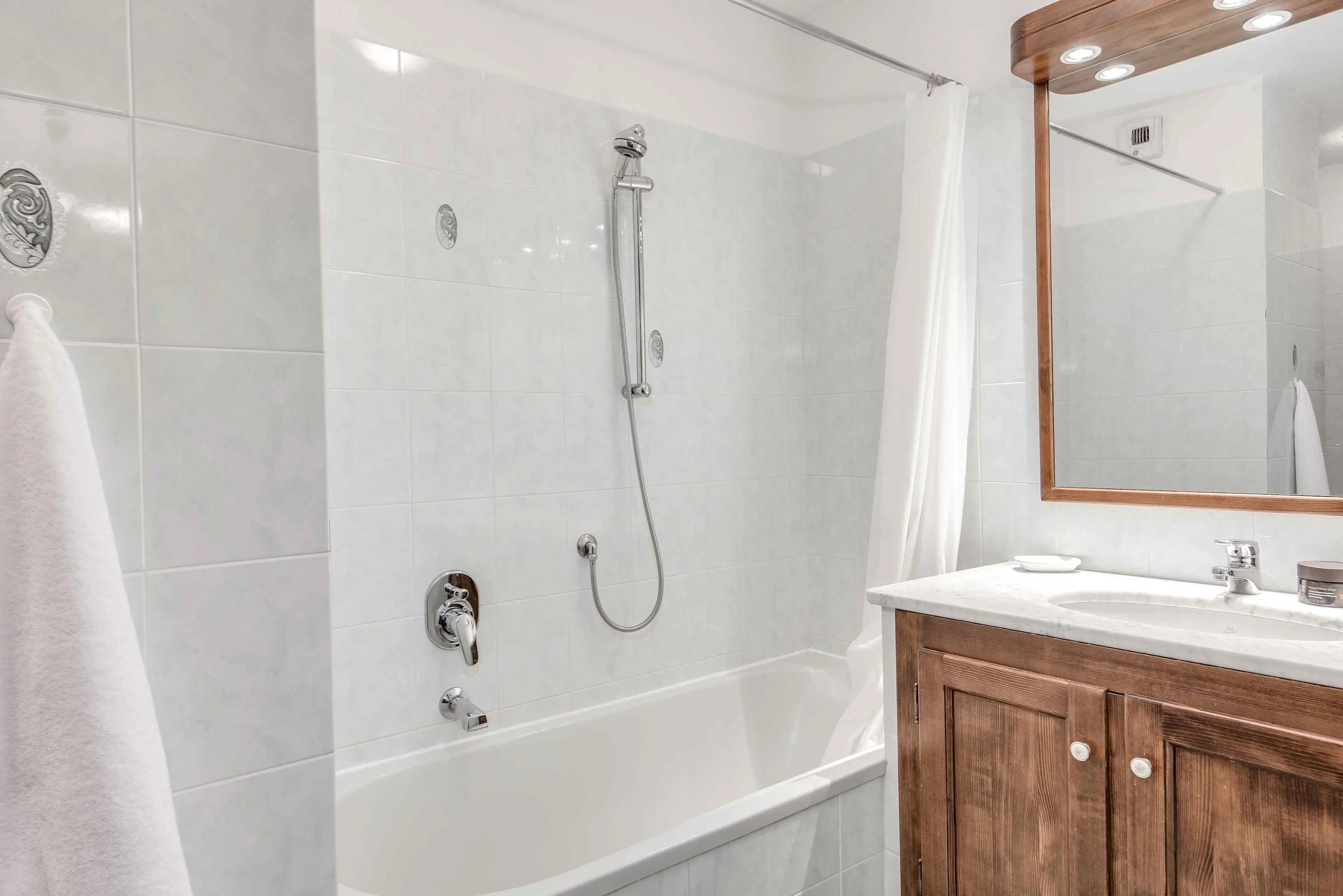 Ensuite bathroom with bath and overhead shower