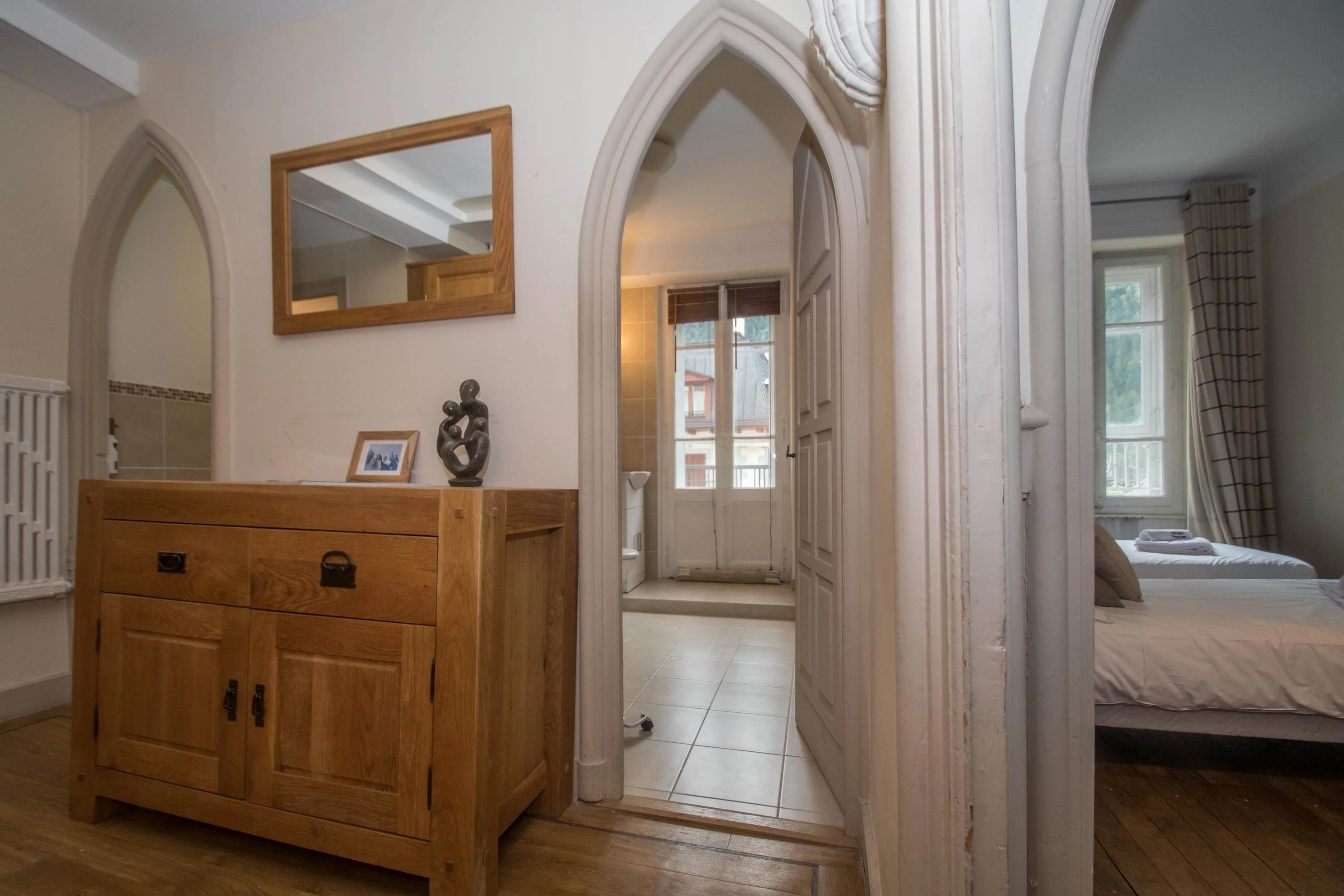 Hallway with feature arched doorways