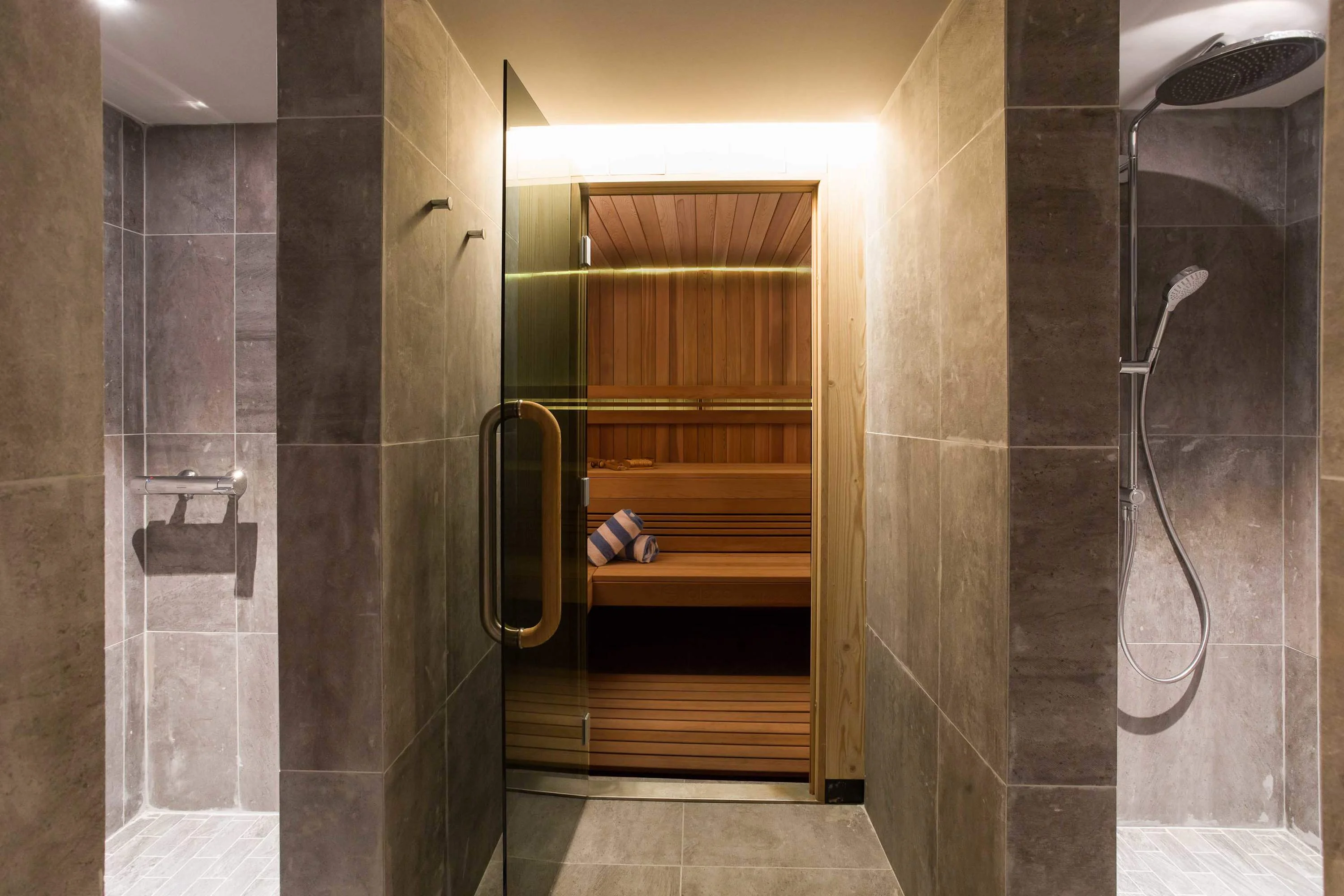 Sauna is spacious and has showers adjacent